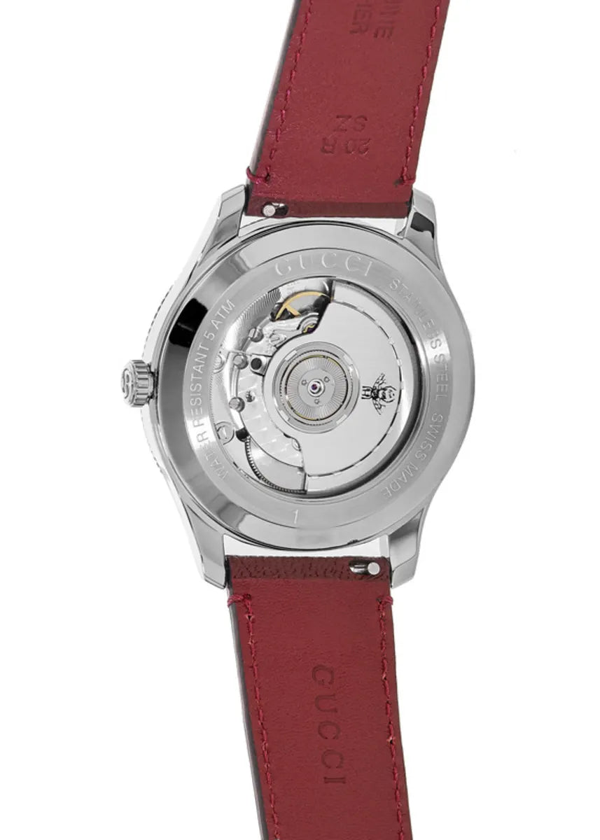 Gucci G-Timeless automatic movement visible through case back with red leather strap