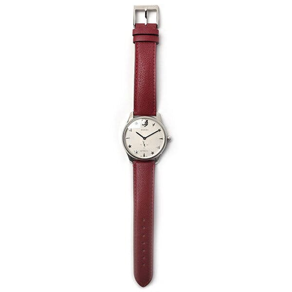 Gucci G-Timeless unisex watch with red leather strap worn on wrist