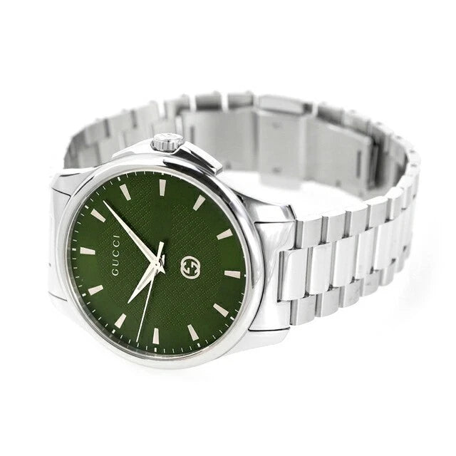 Gucci G-Timeless watch on wrist with green dial and steel link bracelet