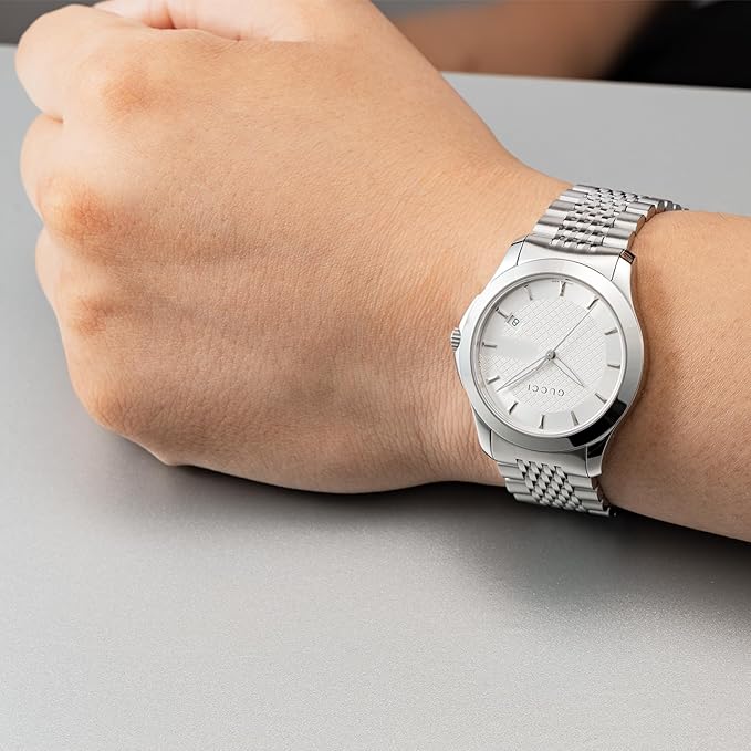 Gucci G Timeless stainless steel watch worn on wrist