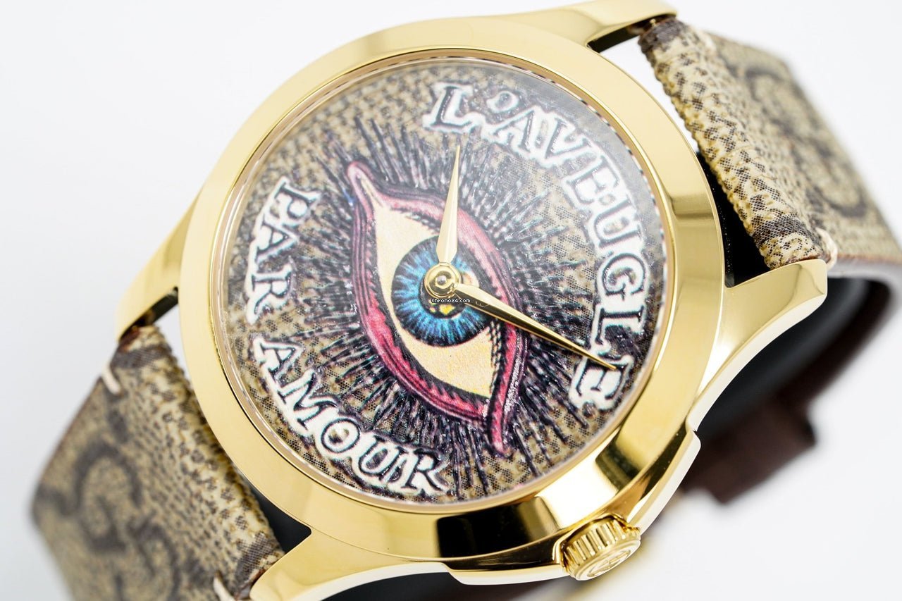 Gucci G-Timeless YA1264022 dial close-up showing eye motif and text