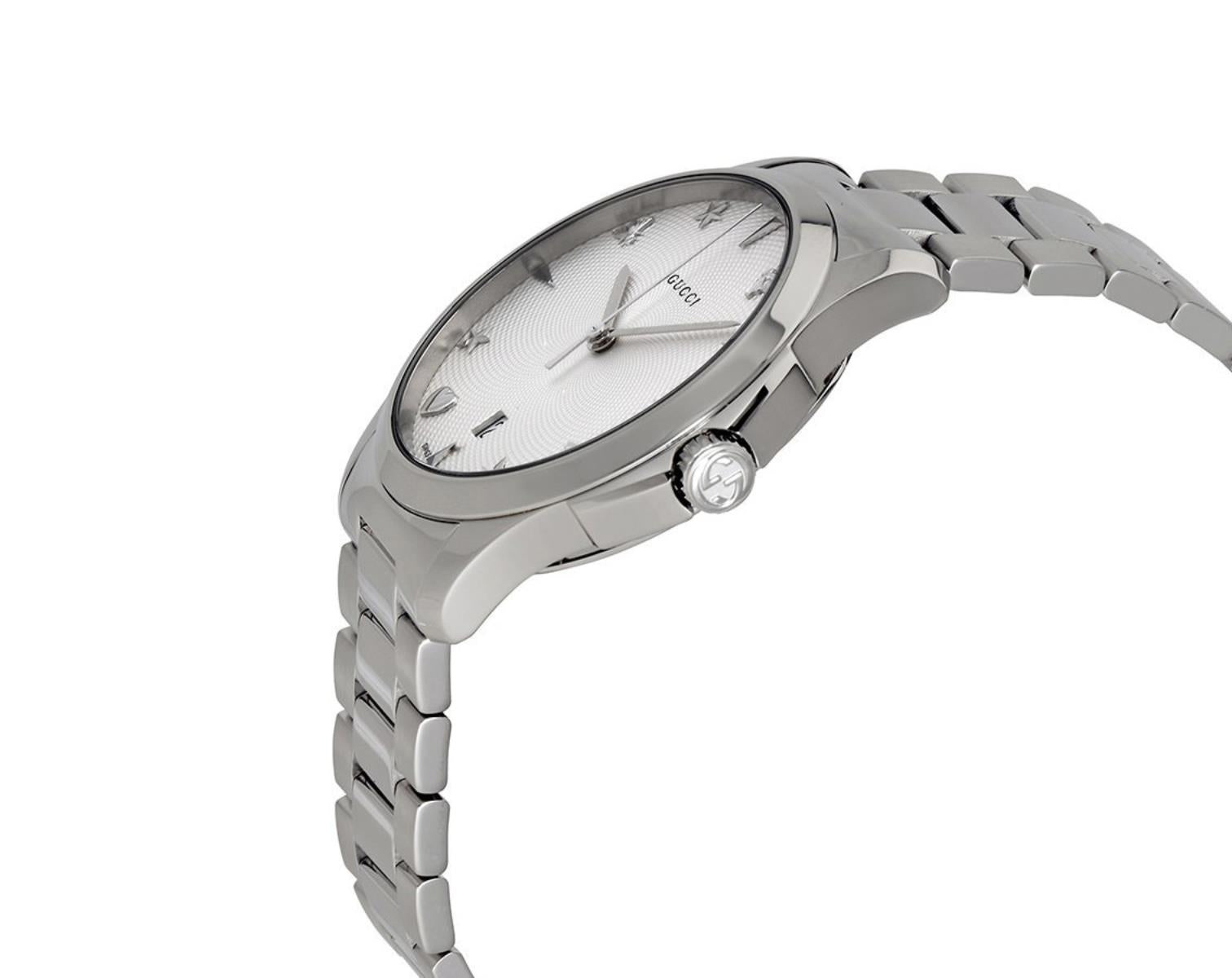 Gucci G-Timeless watch worn on wrist displaying silver dial and star hour markers
