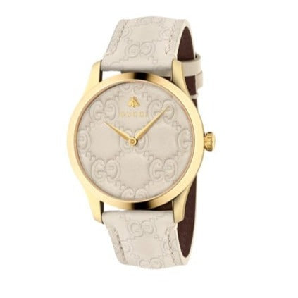 Gucci G-Timeless gold watch angled view white leather strap white dial