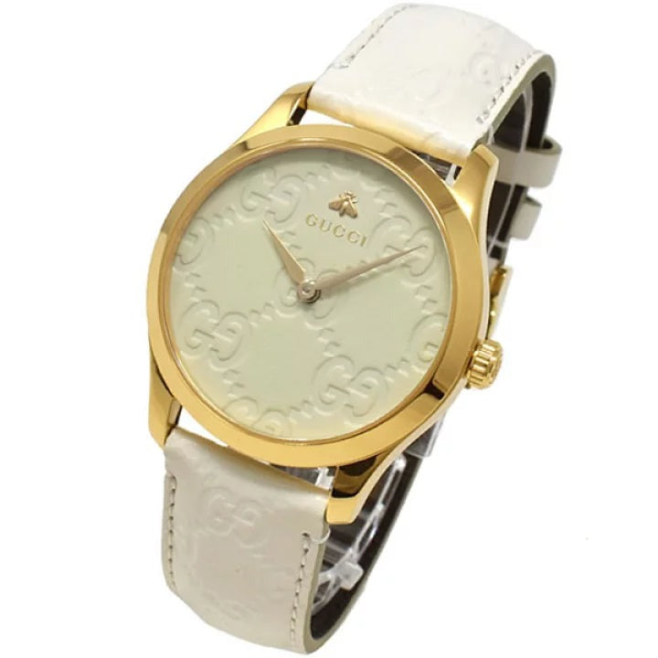 Gucci G-Timeless angled view gold case white dial GG monogram strap