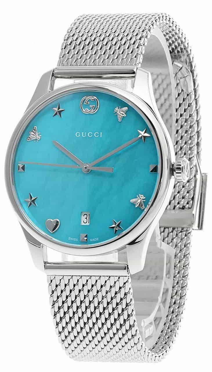 Gucci G-Timeless women's watch displayed at angle showing blue dial and mesh bracelet