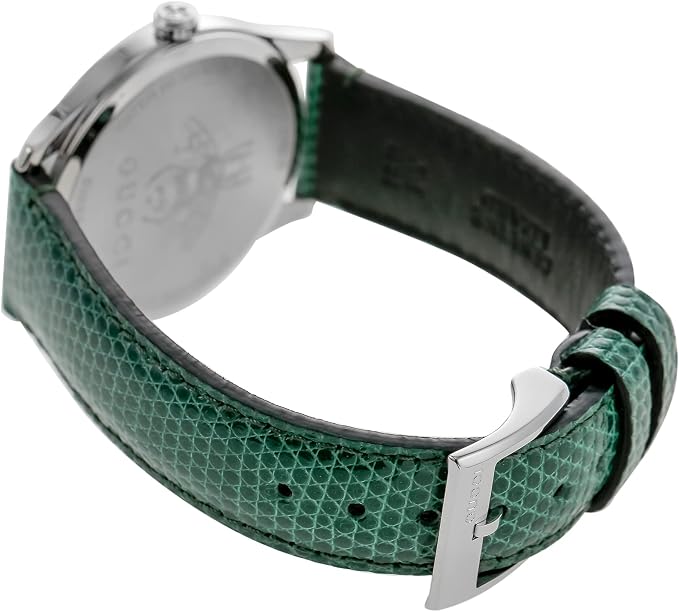 Gucci G-Timeless watch worn on wrist with green leather strap and steel case visible