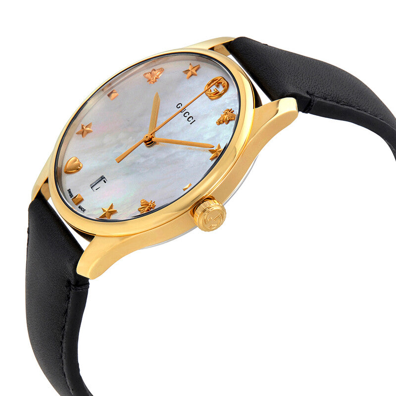 Side angle view of Gucci G-Timeless watch showing mother of pearl dial, gold case, and black leather strap