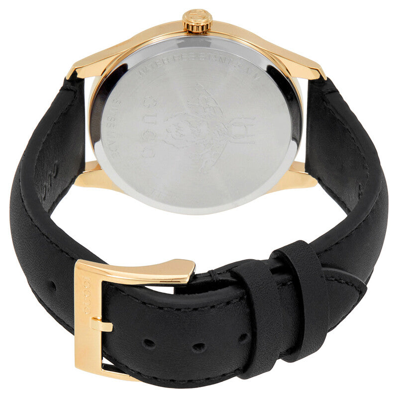 Caseback view of Gucci G-Timeless watch showing gold case and black leather strap with buckle closure
