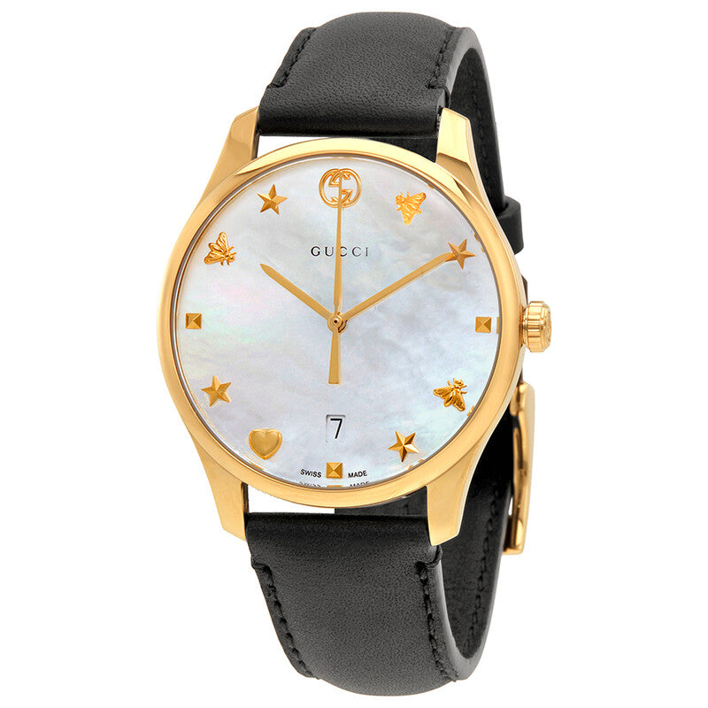 Gucci G-Timeless watch with white mother of pearl dial, gold case, golden star and emblem markers, and black leather strap