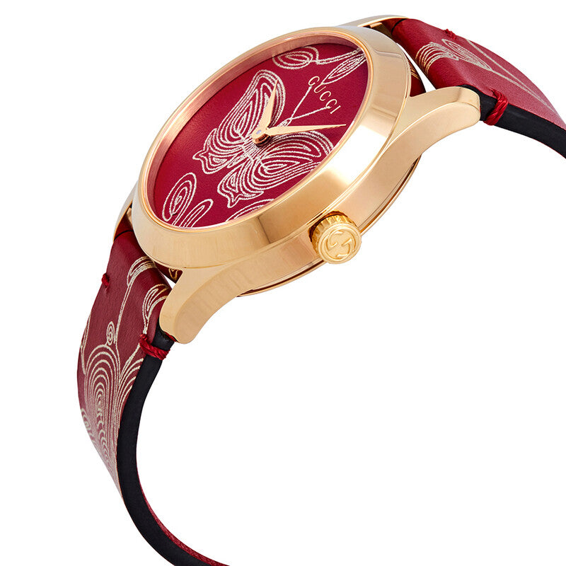 Side profile of Gucci G-Timeless watch showing rose gold case and red leather strap