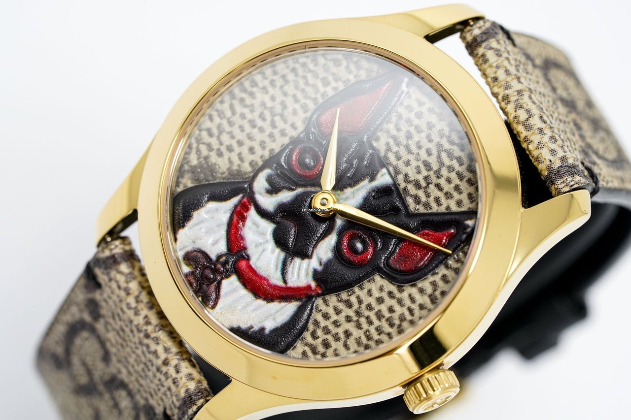 Gucci G Timeless dial detail showing artistic dog portrait and gold-tone hands