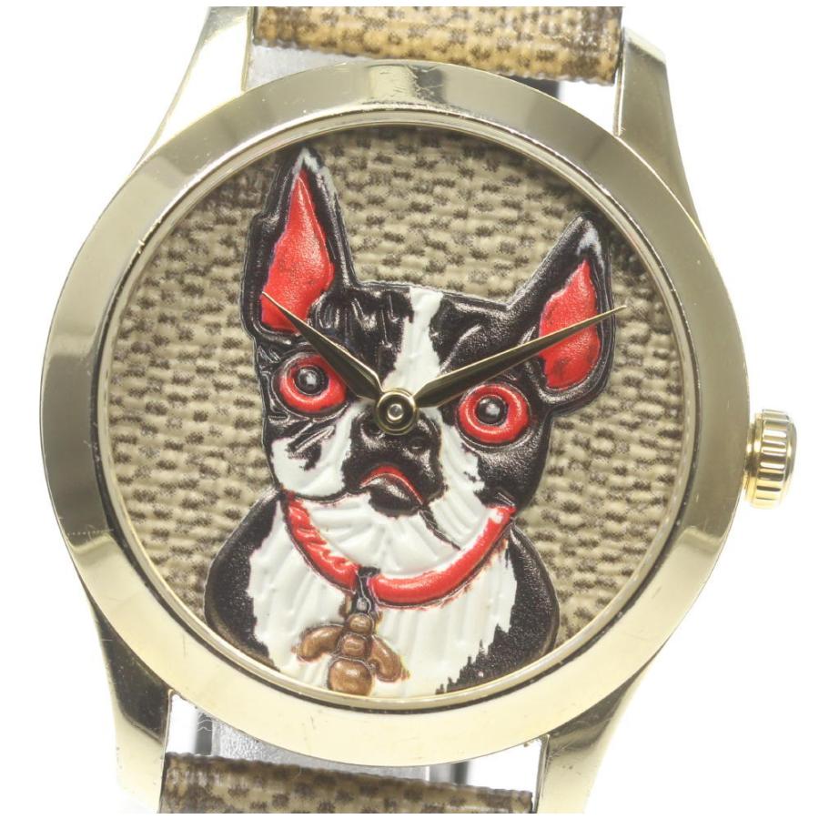 Close-up of Gucci G Timeless dial with red and black bull terrier illustration and gold hands