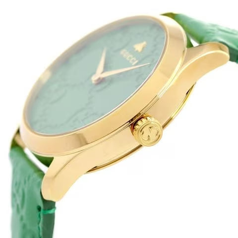 Side angle view of Gucci G-Timeless with gold case and green leather strap