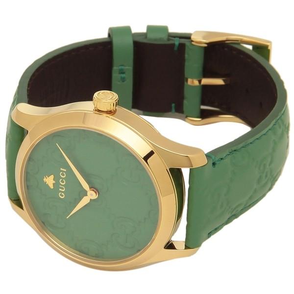 Gucci G-Timeless 38mm watch on wrist showing green strap and gold-tone case