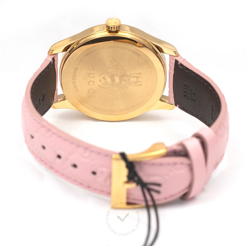 Gucci G-Timeless caseback showing gold-tone case back with engraved Gucci branding and pink leather strap
