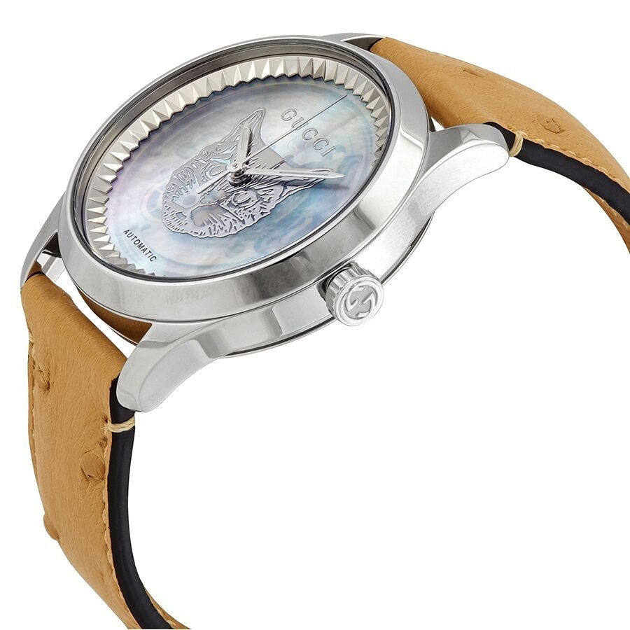 Gucci G-Timeless watch at side angle showing transparent dial with panther motif and tan leather strap detail