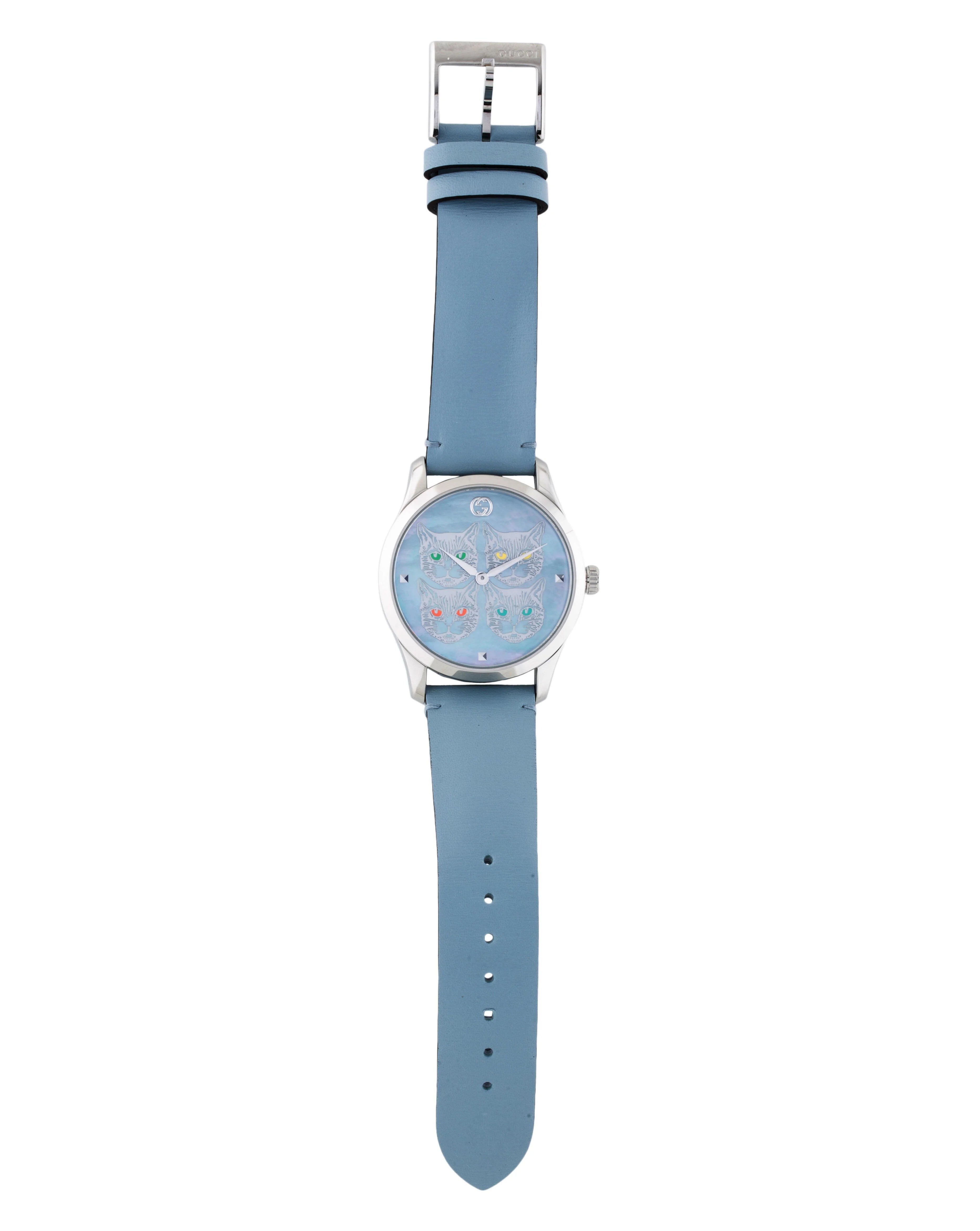 G-Timeless watch displayed vertically showing full strap length and light blue leather band