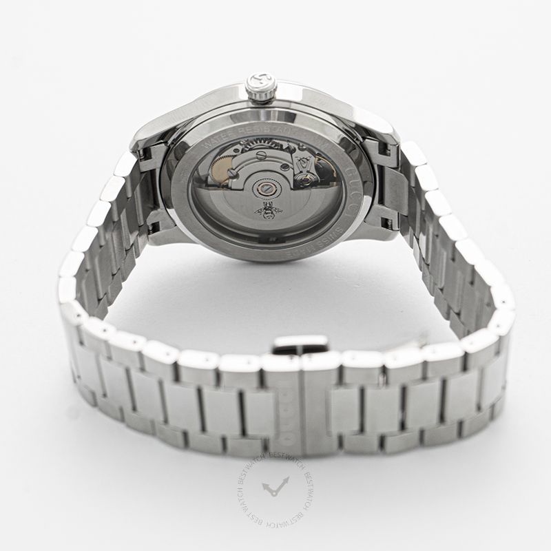 GUCCI G-Timeless automatic watch caseback showing visible movement and stainless steel bracelet