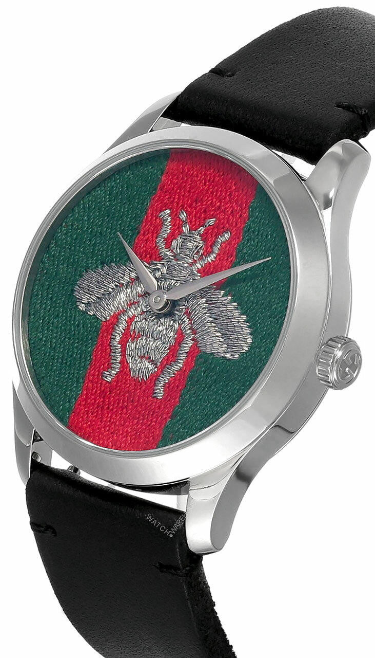 Gucci G-Timeless watch angled view showing silver case and black leather strap