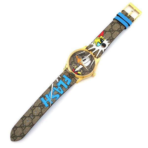 Flat lay of Gucci G Timeless YA1264167 watch displaying full strap length with Disney pattern