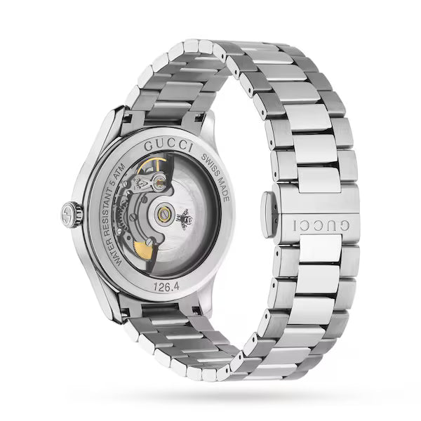 Gucci G-Timeless 38MM automatic watch with silver dial and stainless steel bracelet, angle view showing transparent caseback