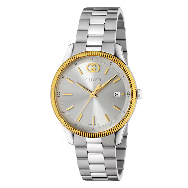 Gucci G-Timeless watch with silver dial, gold bezel, and stainless steel bracelet