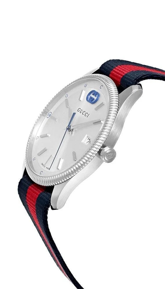 Side angle view of Gucci G-Timeless watch showing stainless steel case and striped nylon strap