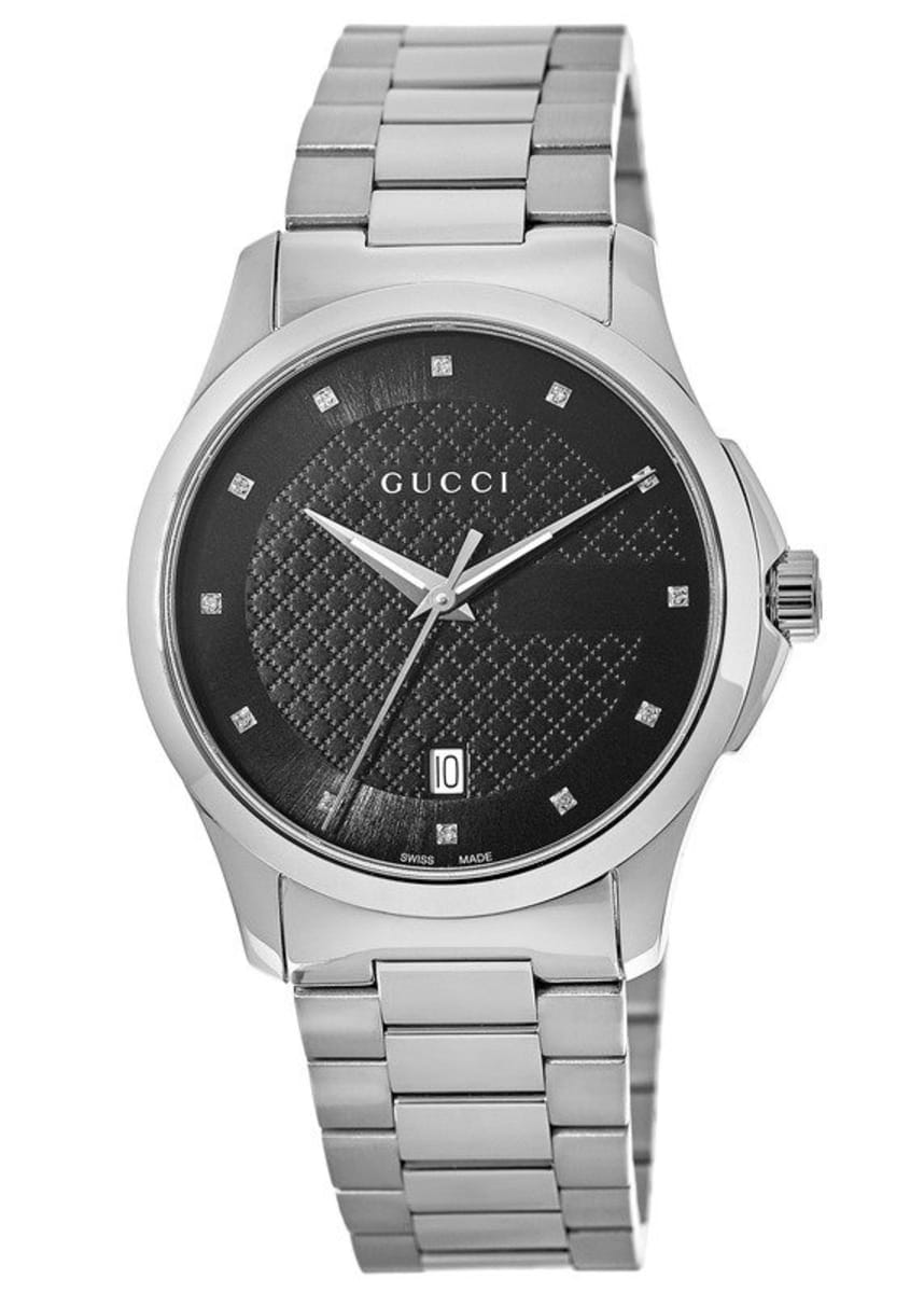 Gucci G-Timeless watch at angle showing stainless steel bracelet and black dial