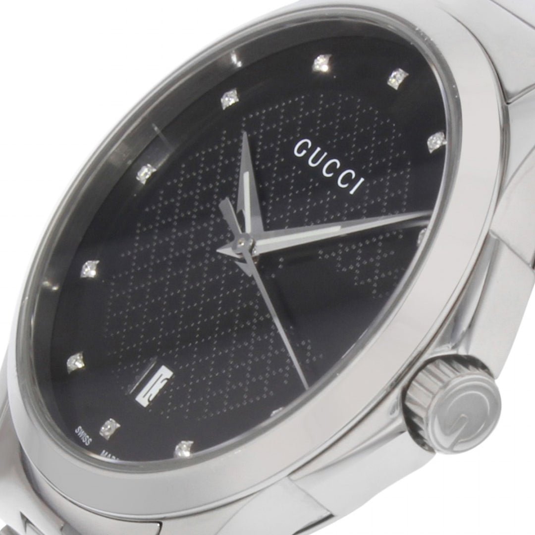 Close-up of Gucci G-Timeless dial with diamond hour markers and textured surface