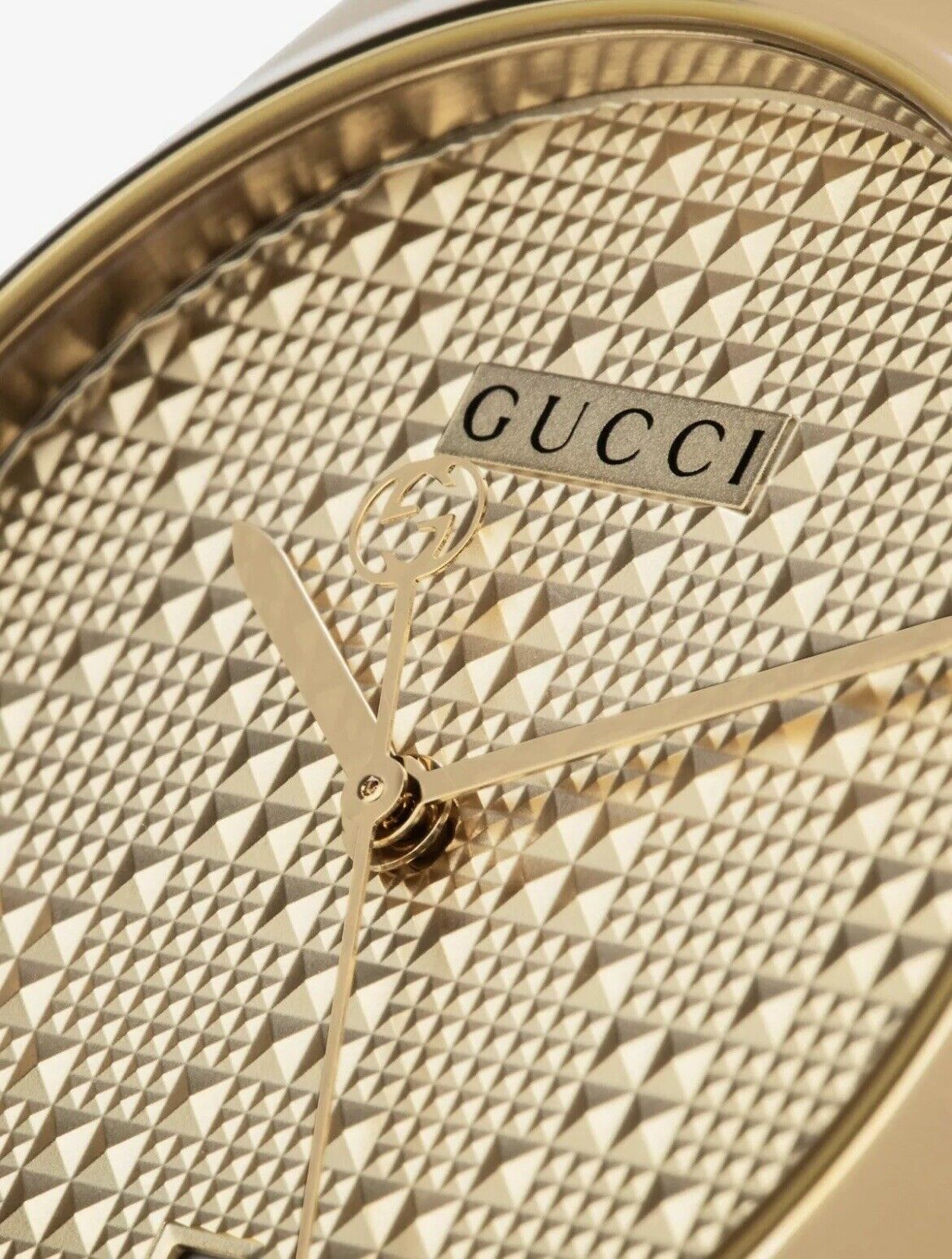 Gucci G-Timeless dial detail showing diamond pattern texture and hands close-up