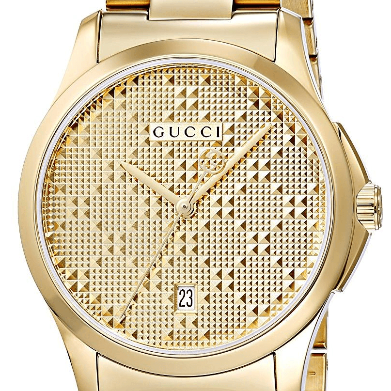 Gucci G-Timeless yellow gold watch close-up of diamond pattern dial with date window