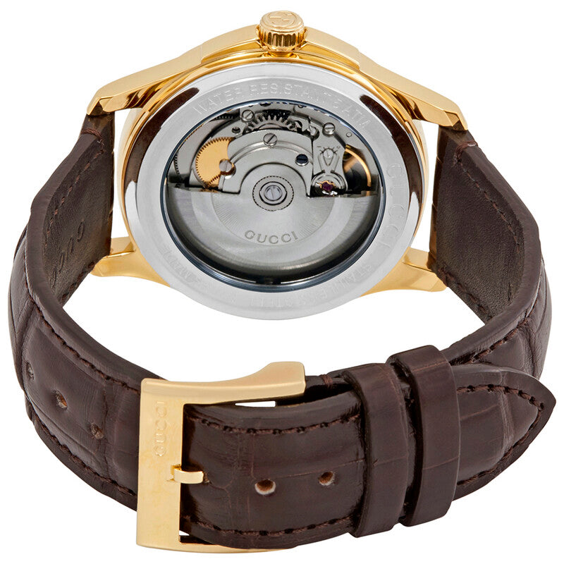 Caseback view of Gucci G-Timeless automatic movement with visible oscillating rotor and brown leather strap