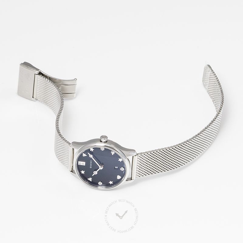 Gucci G-Timeless watch on wrist with steel mesh band and black dial