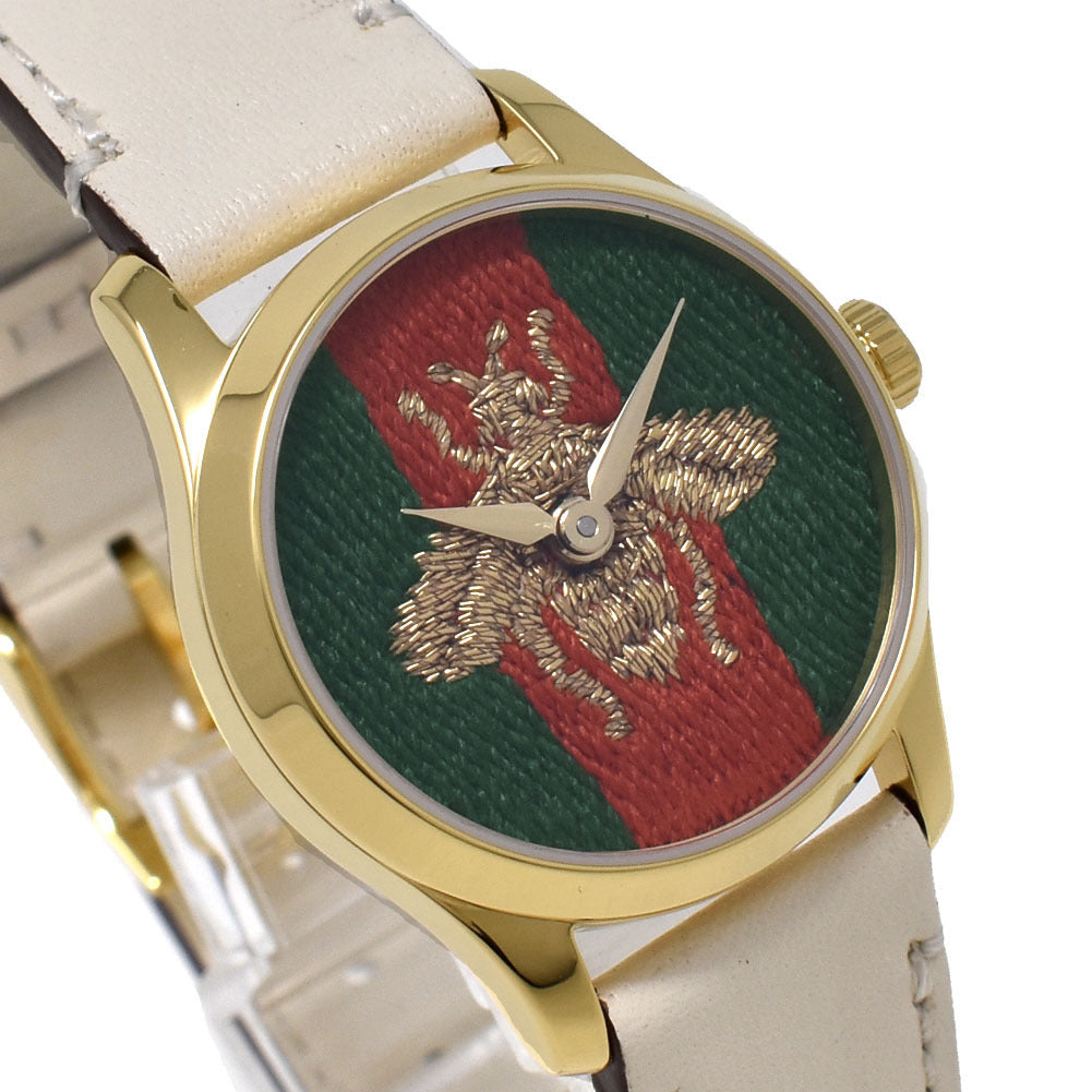 Close-up of G-Timeless dial showing embroidered bee on green and red stripes