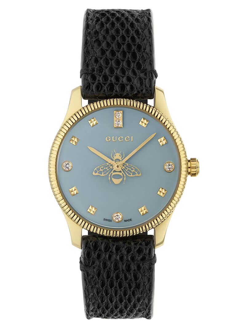Gucci G-Timeless watch with blue dial, gold case, diamond hour markers, bee motif, and black textured leather strap