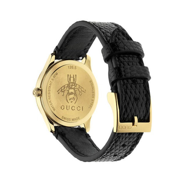 Gucci G-Timeless watch side profile showing gold case, black leather strap, and gold buckle