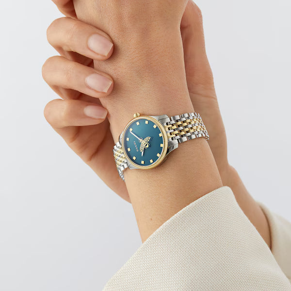 Gucci G-Timeless YA1265029 on wrist with blue dial and two-tone bracelet
