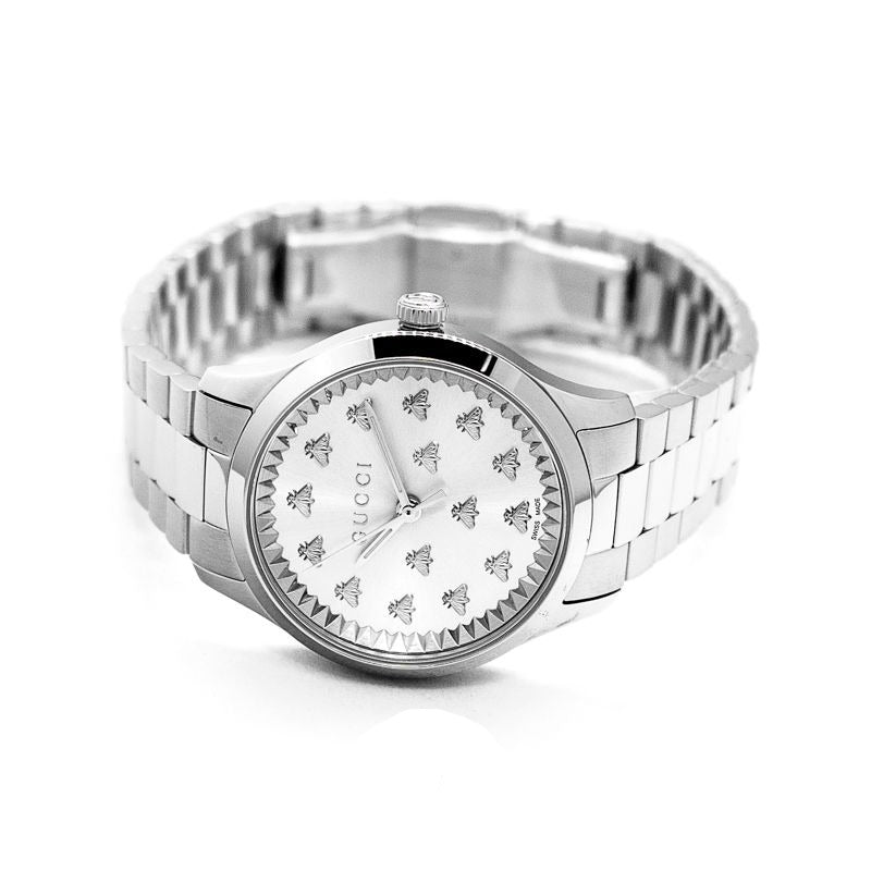 Gucci G-Timeless women's watch displayed on-wrist with silver dial and metal bracelet