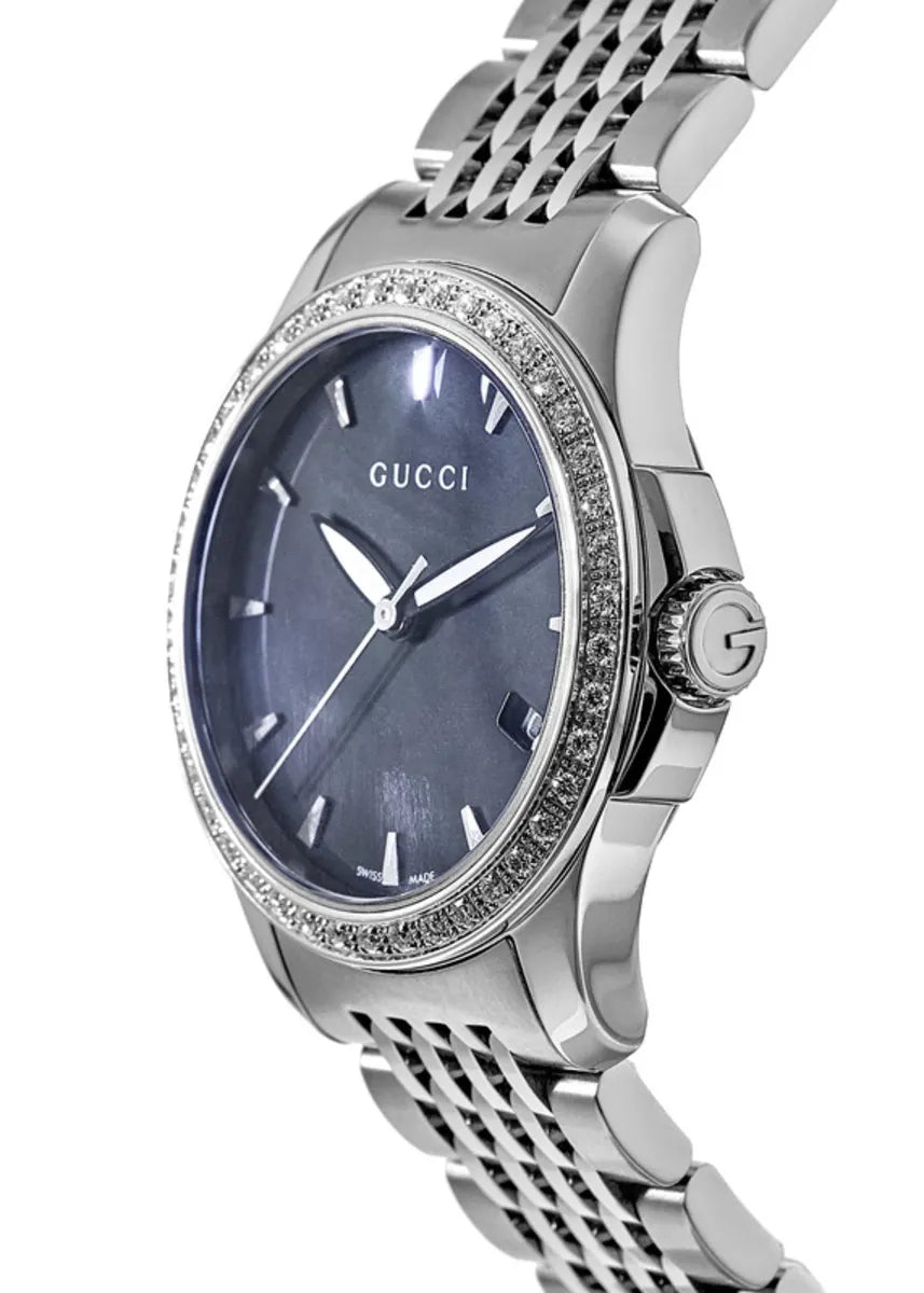 Side view of Gucci G-Timeless womens watch showing diamond bezel and steel bracelet