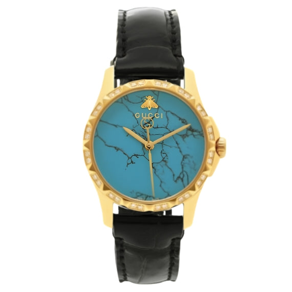 Gucci G-Timeless watch with turquoise dial, gold-tone case, and black leather strap