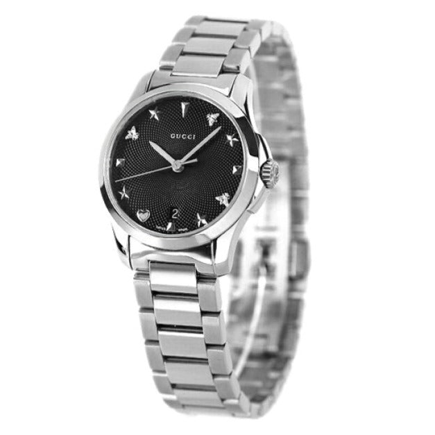 GUCCI G-Timeless 27MM quartz watch worn, displaying black dial with Gucci charms and steel bracelet