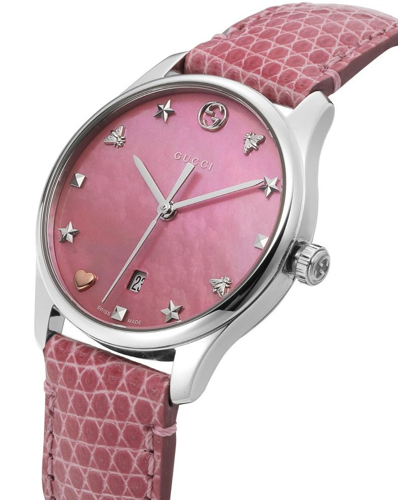 Angled view of Gucci G-Timeless watch showing pink quilted leather strap and diamond hour markers