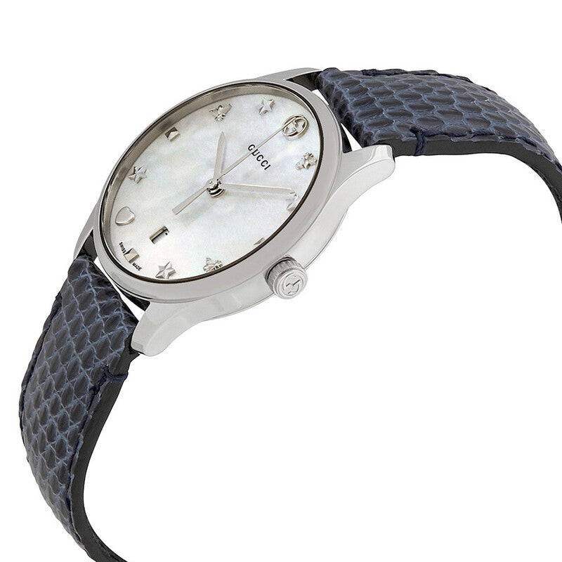 Gucci G-Timeless watch on angle showing silver case and blue leather strap
