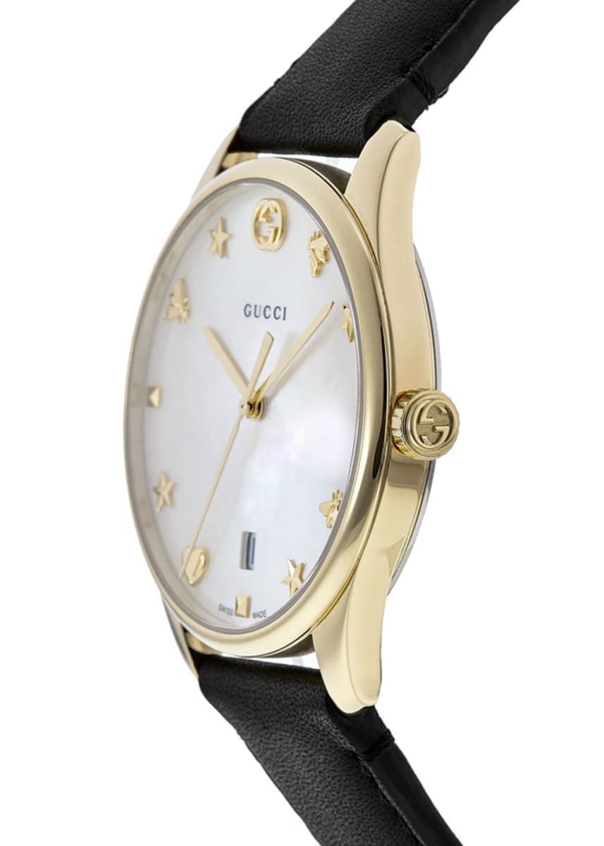 Side angle view of Gucci G-Timeless watch with mother of pearl dial and gold-tone case