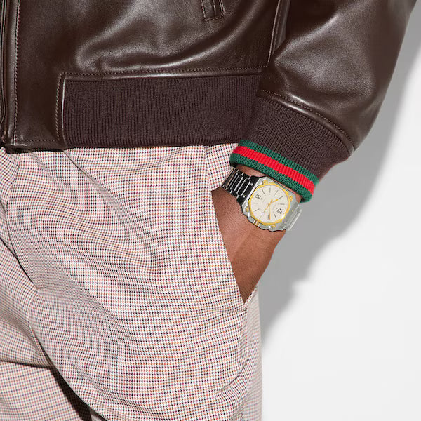 Gucci G-Flat watch worn on wrist with two-tone case and steel bracelet