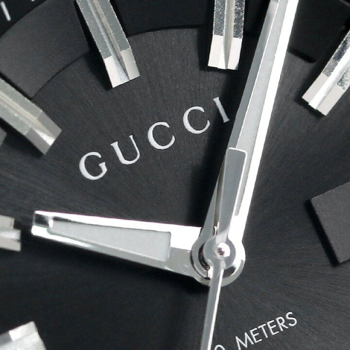 Close-up of Gucci GG2570 black dial showing logo and hour markers
