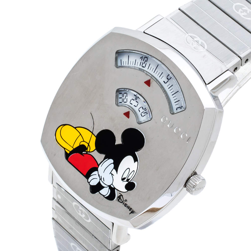 Gucci Grip watch showing Mickey Mouse holding Pluto on silver dial at angle view