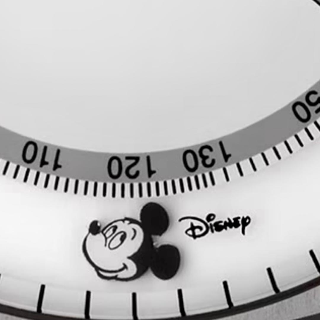 Close-up of Mickey Mouse silhouette and Disney branding on white watch dial