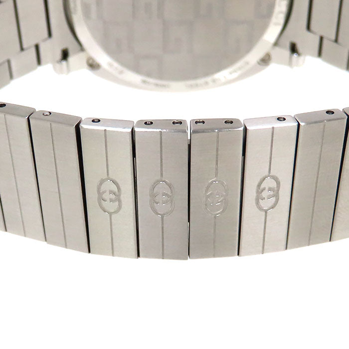 Gucci Grip silver steel bracelet links with engraved GG pattern close-up