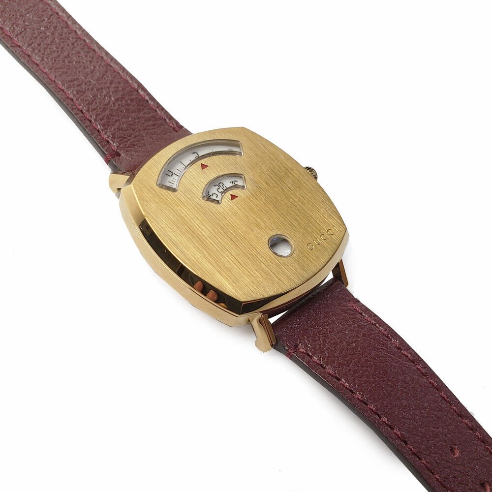 Angled view of Gucci Grip watch showing case profile and burgundy leather band attachment